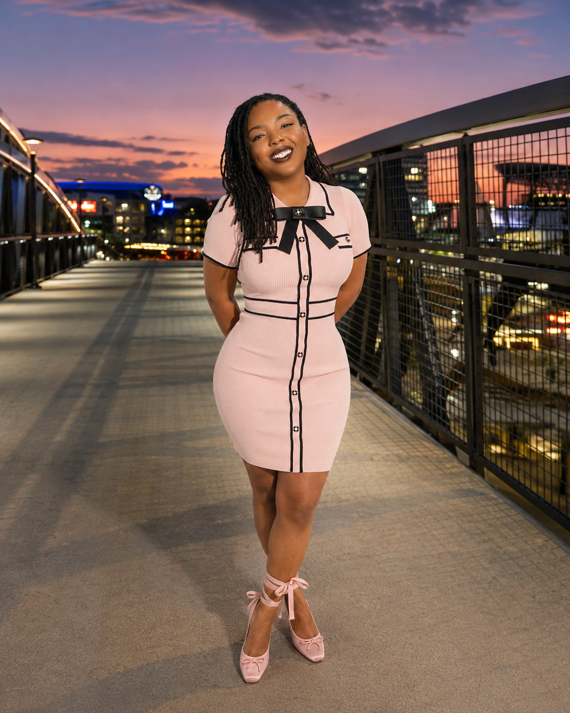 Moremi Wolcott on the pedestrian bridge at The Battery Atlanta at dusk